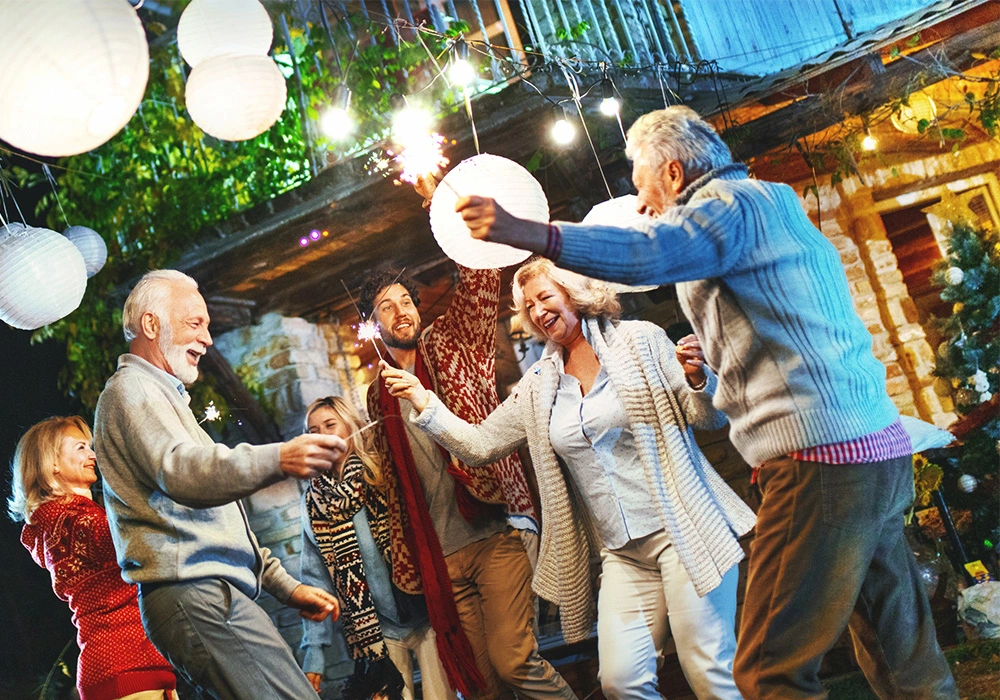 A group of six people of different ages and genders dancing, smiling and enjoying life.
