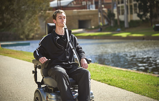 Patient mit neuromuskulärer Erkrankung im Rollstuhl